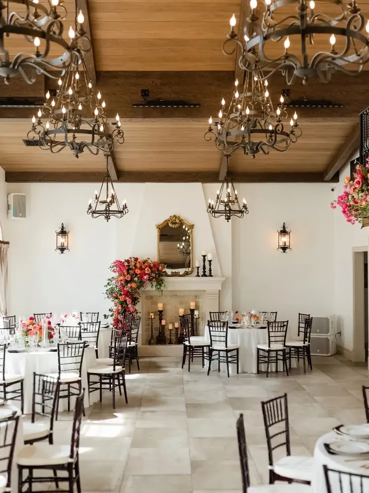 Vaulted ceiling and iron chandeliers above reception tables at 9 Aviles in St. Augustine