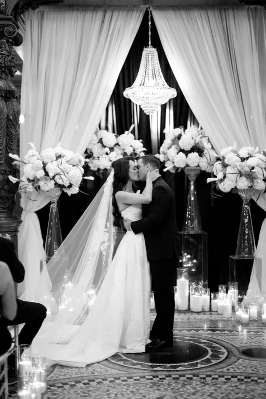 Wedding ceremony kiss under the chandelier at the Grand Parlor Rotunda Flagler College St. Augustine