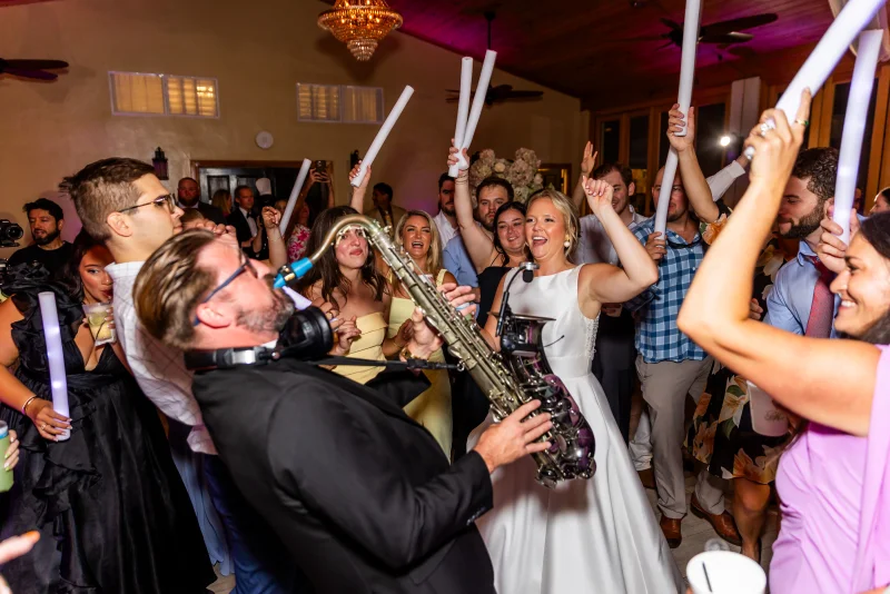 Wedding guests holding glow sticks on dance floor at Fountain of Youth
